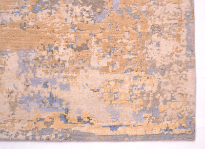 Corner detail of abstract carpet which artisanally handcut .Cotton warp threads are not visible as a bound ends. Overall area of golden cream silk. Ground base colours of light blue, light cream and light beige/cream.
