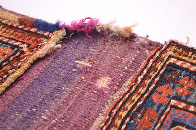 Antique khorjin rug underside detail in dark purple textile with stitched edges