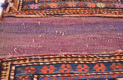 Antique khorjin textile in maroon and purple, with geometric border motifs