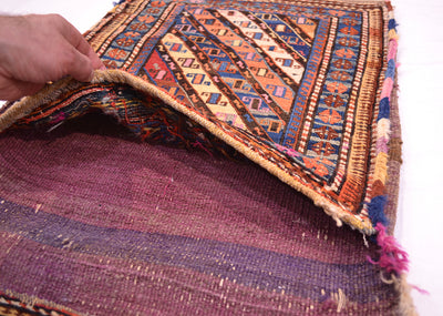 Antique khorjin rug close-up of blue-and-rust geometric bands with multicolor fringe