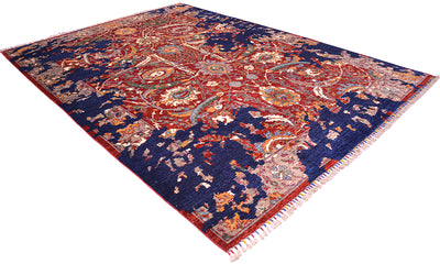 A transitional oriental-style area rug with a deep navy blue field, featuring an intricate central medallion and floral motifs in red, orange, beige, and light blue, finished with a fringed edge.