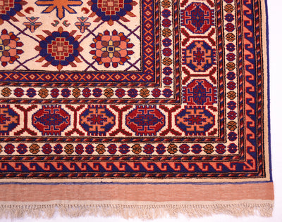 Kabul silk and wool rug corner detail with red medallions, blue accents, and fringed edge