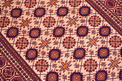 Close-up of Kabul silk and wool rug pattern: cream field with blue and red rosettes