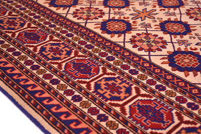 Close-up of Kabul silk and wool rug border with red, blue, and geometric zigzag bands