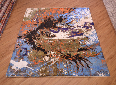 Splash carpet shows an abstract design in colours of blue, black, brown, orange and white.