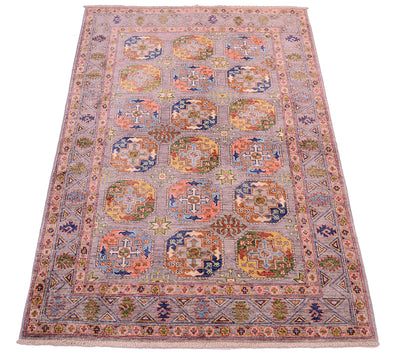Overall view of geometric rug with a soft grey field and ersari  fil pai design with modern colours.  With blues, greens, gold and coral pinks.