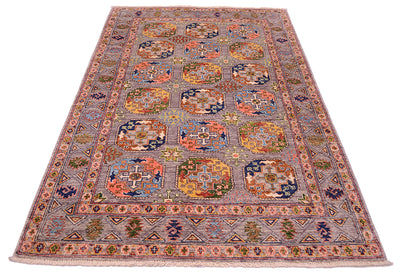 Geometric design of sultani rugs with colourful guls and als secondary devices with an all over soft grey field, Traditional design but reinterpreted colours.