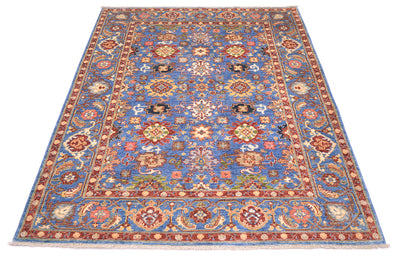 View of Handwoven rug with fmaous Sultanabad Persian design with all over field pattern with flowerheads and palmettes wirh elelgant border with rosettes, vines and leaves.  Warm gold yellow warm the blue field. 