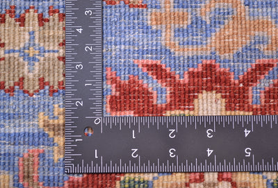Back of handwoven rug showing knot density and quality wool dyed with natural vegetable dyes with reds, blue, gold and creamas well as accents of green. 
