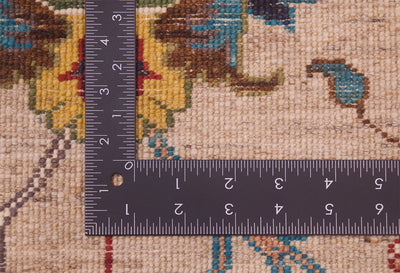 Detail of back of rug with stone beige field and colourful floral motifs showing fine knotting and back of handknotting.