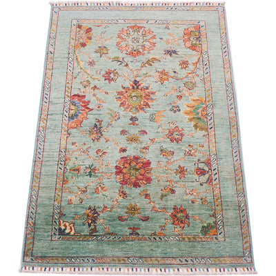 Highly floral main field of Afgha Handmade rug wity flowing floral filled field and more understated border.  Field colour of topaz green-aqua and rust and ambers of main decorative field.