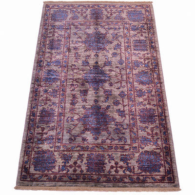 All over floral design with gernouos flowerheads in blue with a  rich red outlings on a contrsting daerk silver ground with pure wool pile.