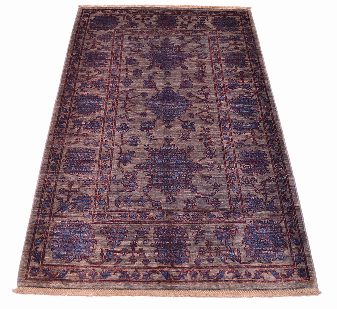 Persian floral design Afghan Rug wih rich blue and grey colourations delineated outlines. Wide spacious border and three central floral motifs in main field.
