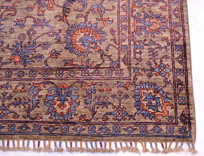 Corner detail of handknotted rug with cotton warps bound with woollen yarn with corresponding colourways.