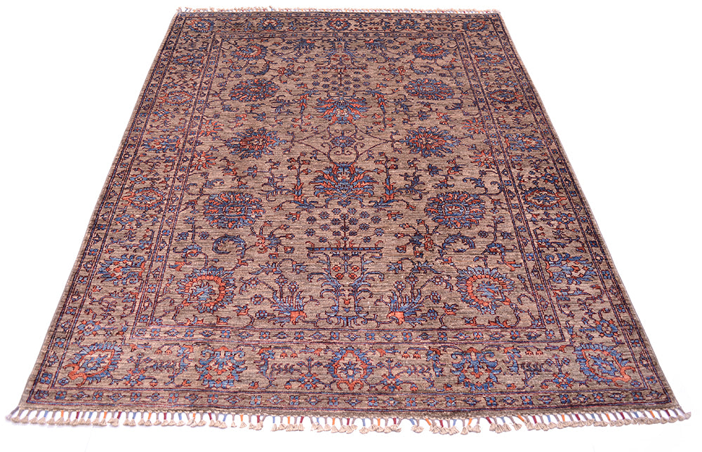Floral design carpet handmade and hadnknottined with ornate floral motifs and vase and flowers elemetns with blossoms, palmettes and leaves. Two toned blue and orange detailing.