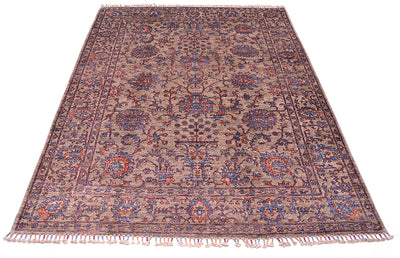 Floral design carpet handmade and hadnknottined with ornate floral motifs and vase and flowers elemetns with blossoms, palmettes and leaves. Two toned blue and orange detailing.