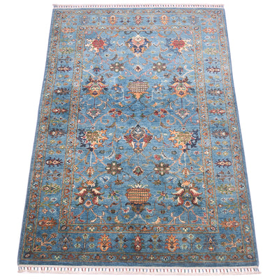 All over floral design of handmade blue sultani rug with floral design of antiquity with modern cheerful colours. Multiple floral motifs throughout filed and border.