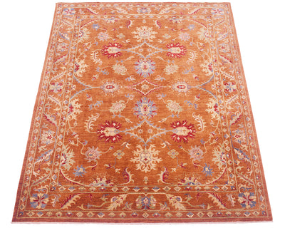 All over view of Sultani carpet with traditional floral design and cinnamon-amber toned pure wool pile ground colour with multiple floral leaves and decorative palmettes in field and border. 