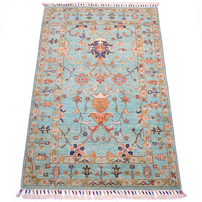 All over flroal compositions of handknotted Afghan Sutani rug with vibrant topaz coloured main field colour with a floral network of interconnecting motifs.