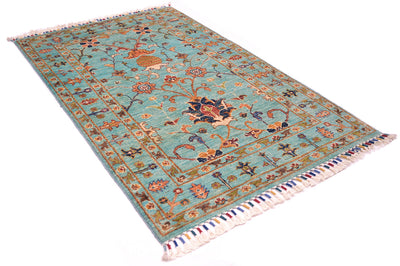 Angeled view of multcoloured rug with handknooted pure wool pile and a aqua- light turquoise main field colour with traditional floral Persian design. 