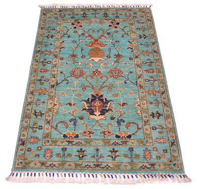 Intricate floral design showing multicoloured main field floral detailing on a light turquoise background.   Cotton warps are tied and bound in a colourful fashion with woollen yarn.