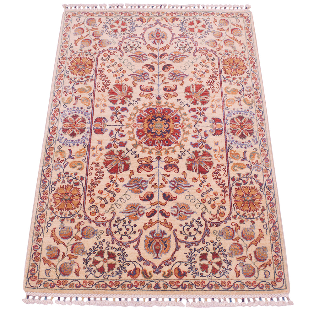 Cream rug with ornate red and blue floral motifs, central medallion, and fringe