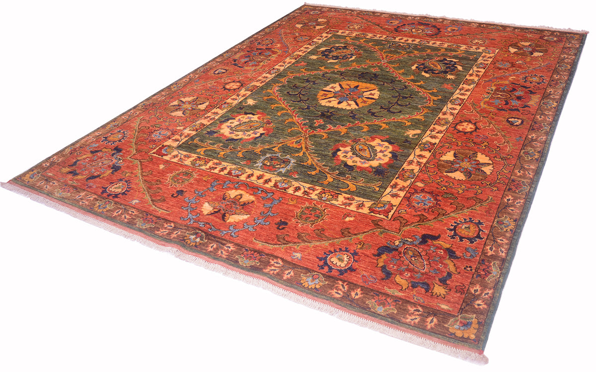 A traditional Afghan Suzani design handmade carpet with a complex floral and geometric pattern, featuring a dominant rust-red field, a dark green central medallion, and cream, blue, and orange accents, shown on a plain white background.