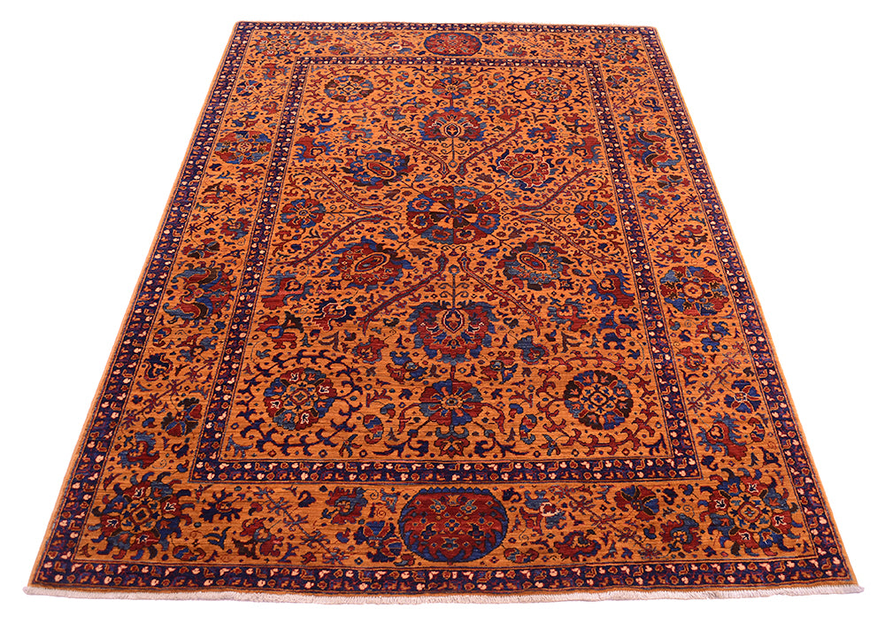 A rectangular Suzani-style area rug with an intricate floral and medallion pattern, featuring a warm amber field with navy blue, red, and beige details.