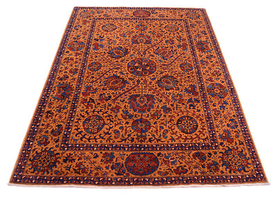 A rectangular Suzani-style area rug with an intricate floral and medallion pattern, featuring a warm amber field with navy blue, red, and beige details.