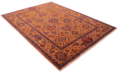 An oriental-style Afghan Suzani area rug with a warm amber field, intricate floral motifs, and a dark navy blue border, shown from an elevated angle on a white background.