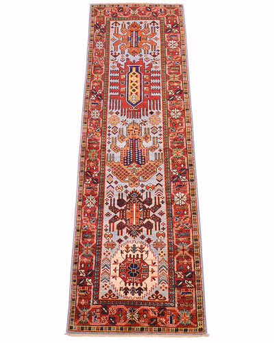 A 8ft long rectangular antique style Taimani runner with an intricate geometric and tribal pattern, featuring a pale blue field, and red borders, shown flat against a white background.