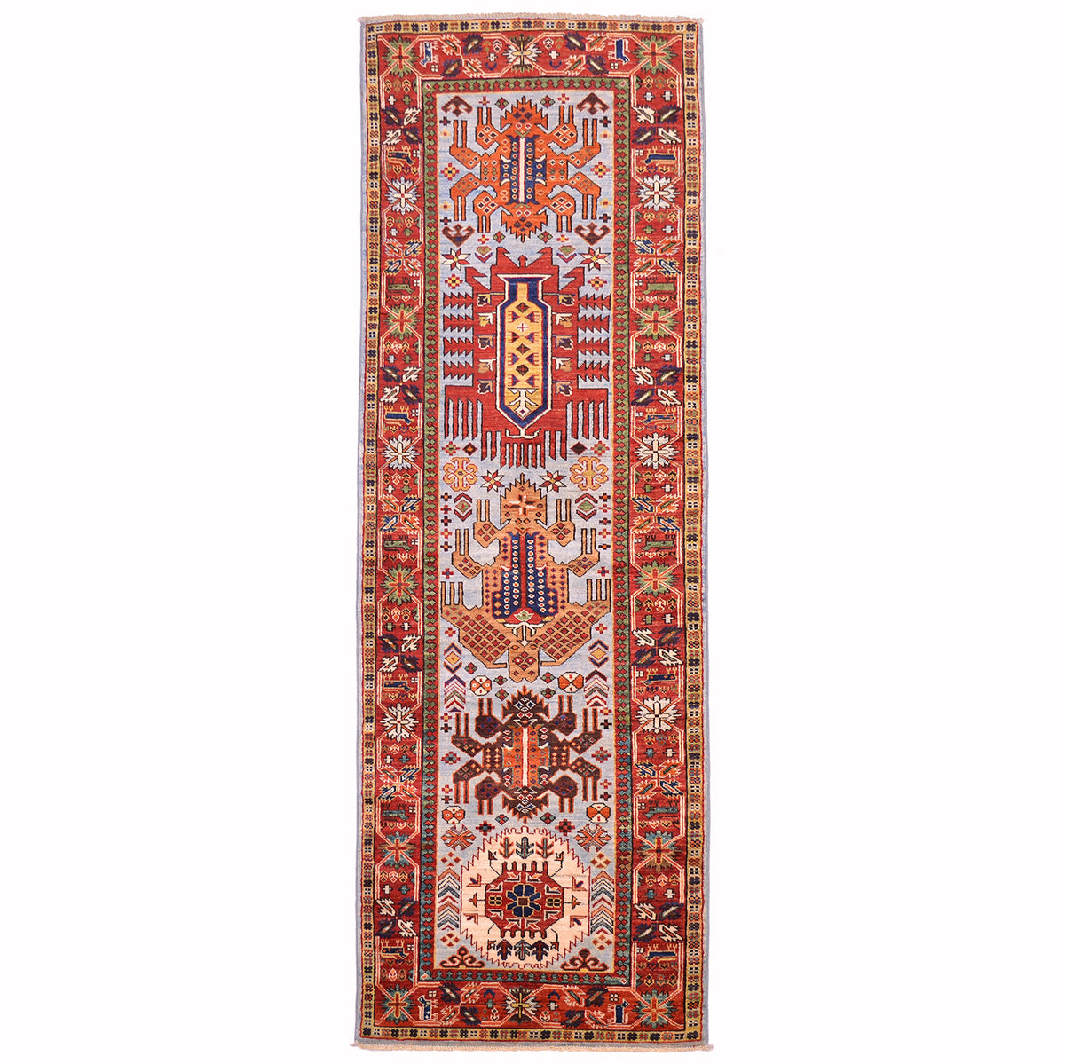 Antique style Taimani runner with geometric medallion design on a light blue ground with red border.