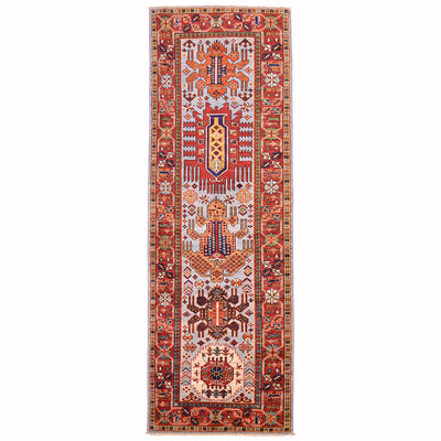Antique style Taimani runner with geometric medallion design on a light blue ground with red border.