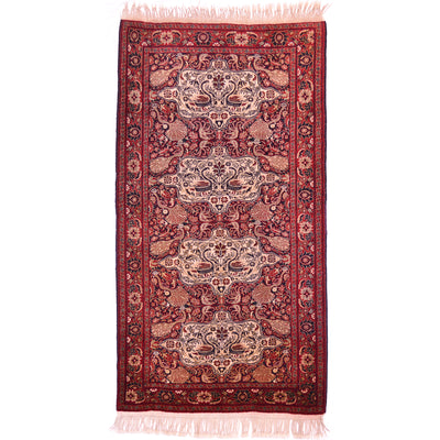 Old Belouch-Tavusi rug with red medallion pattern and cream accents, pink fringed ends.