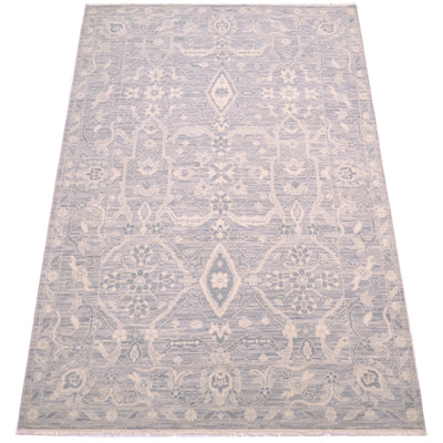A rectangular tonal rug with a traditional geometric pattern in light grey and cream, shown flat against a white background.