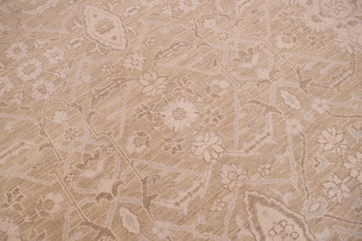 A close-up of a beige and cream patterned tonal rug with a traditional floral design.
