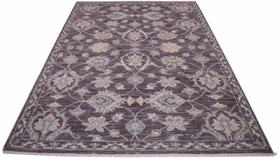 A rectangular Tonal rug with an intricate traditional floral pattern in shades of pewter, beige, and light blue, shown from a top-down perspective on a white background.