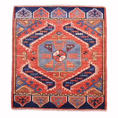 Fine antique style Afghan mat with geometric medallion design on a rust/terracotta ground.