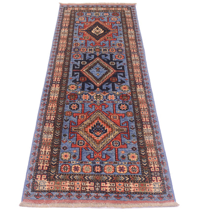 A traditional 6ft long Blue Turkmen tribal style runner rug with a complex geometric pattern in shades of blue, red, beige, and black, shown flat against a white background.