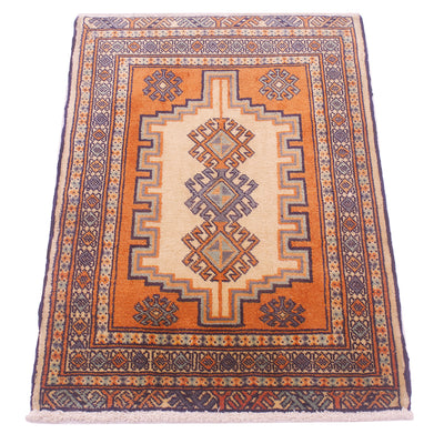 A rectangular hand-knotted area rug mat with a traditional geometric pattern, featuring a central cream field, an orange-brown field, and a dark navy blue edge