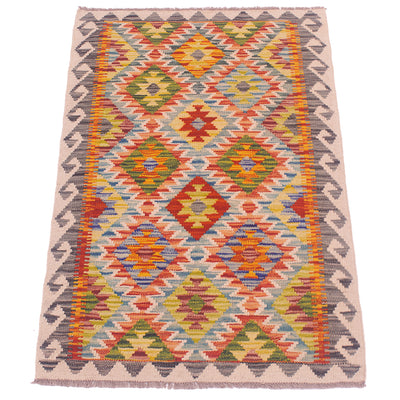 A flatweave Afghan multicolour kilim rug with a vibrant geometric diamond pattern in orange, red, yellow, green, blue, and grey on a beige background.