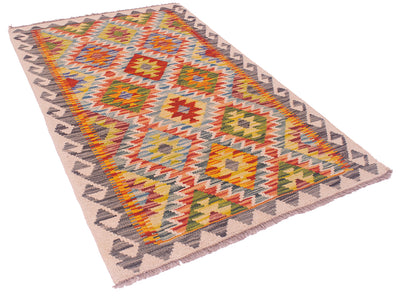 A rectangular Multicolour Afghan kilim rug with a geometric diamond and zigzag pattern in multiple colours, including orange, yellow, green, blue, red, and grey, on a cream background with fringe.