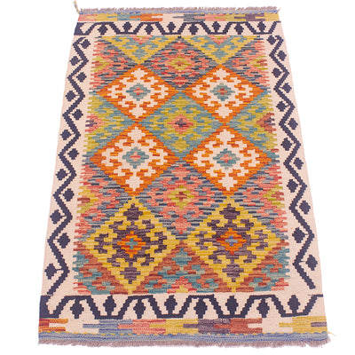 A flatweave geometric kilim rug with a cream-colored base and a vibrant multicolor pattern of orange, yellow, blue, and pink diamonds, framed by dark navy borders.
