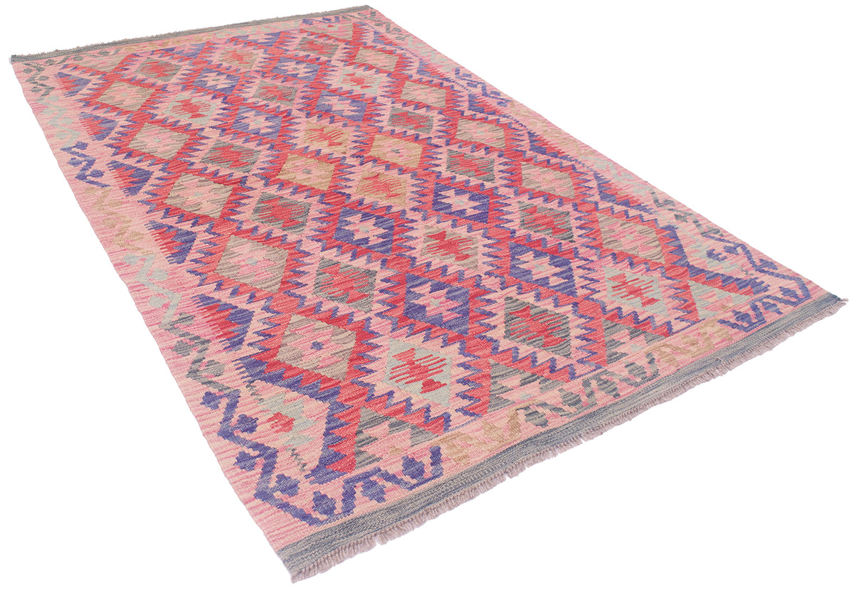 A 6x4 Afghan kilim area rug with a geometric diamond pattern in pink, red, blue, and beige, featuring a fringed edge on a white background.