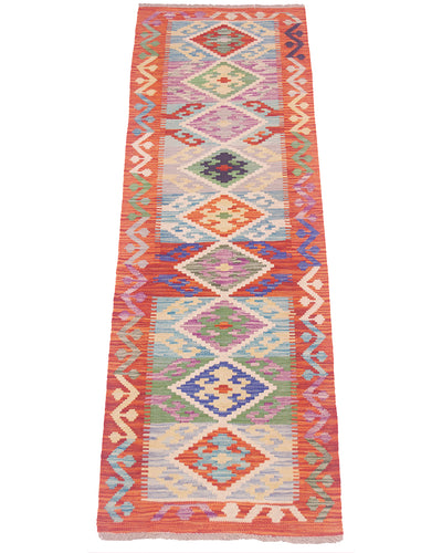 A 6ft long rectangular Multicolour Afghan Kilim short runner rug with a vibrant geometric pattern, featuring a coral-red border and multiple colourful diamond motifs in the centre on a white background.