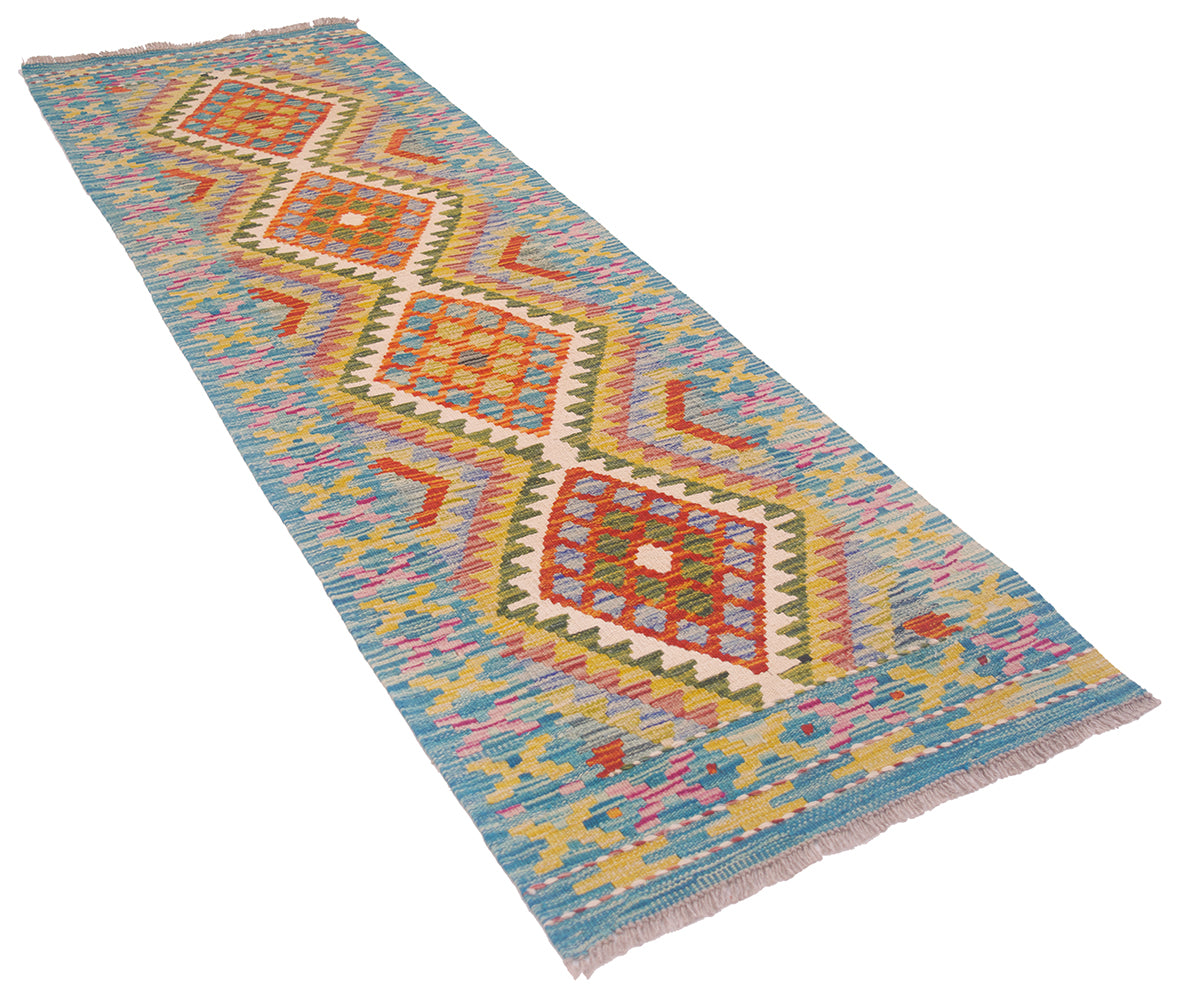 A narrow woven Afghan Kilim Short Runner rug with a coloruful geometric diamond pattern, shown diagonally on a plain white background.