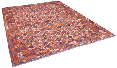 Handwoven kilim rug with multicolor geometric pattern in a diagonal corner view.