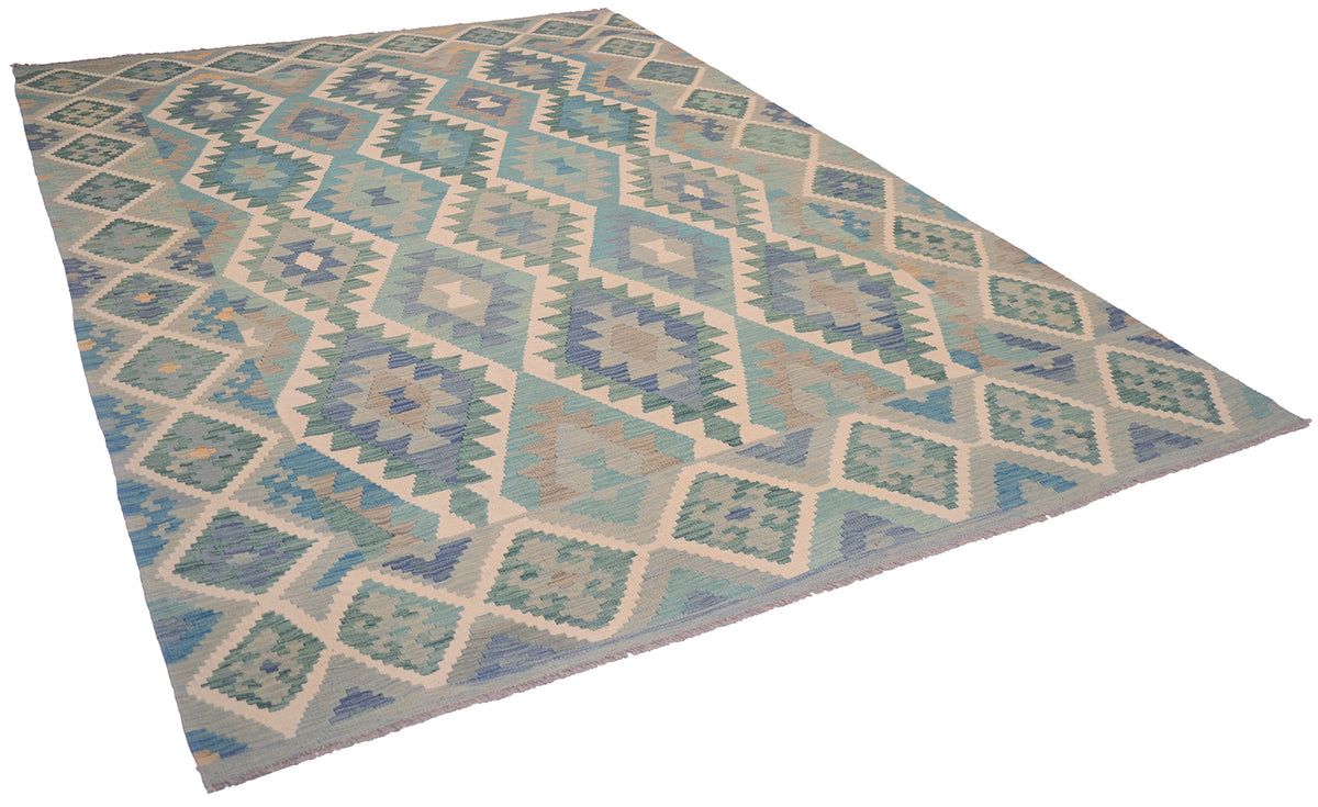 A Kilim Afghan rug with a geometric diamond pattern in shades of green, blue, teal, beige, and grey, shown from an elevated perspective against a white background.