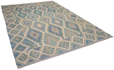 A Kilim Afghan rug with a geometric diamond pattern in shades of green, blue, teal, beige, and grey, shown from an elevated perspective against a white background.