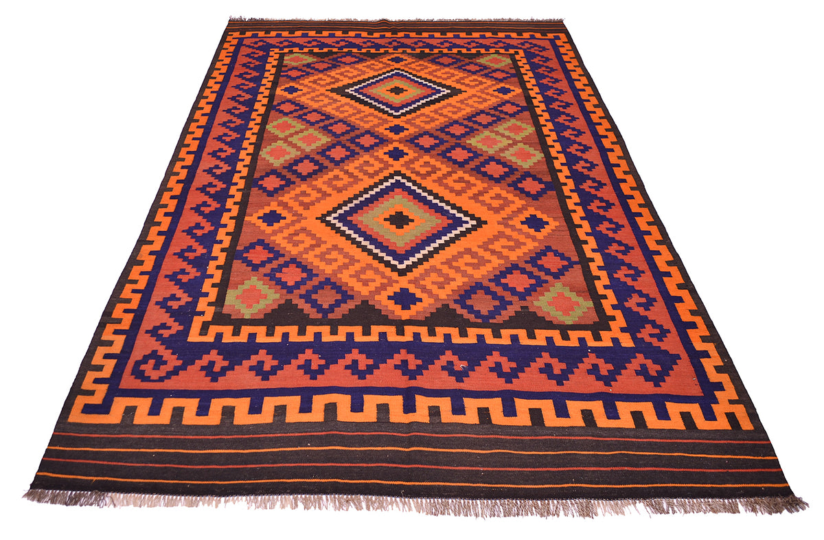 Colorful vintage Kilim rug with central diamond design in orange, blue, and rust; fringed.